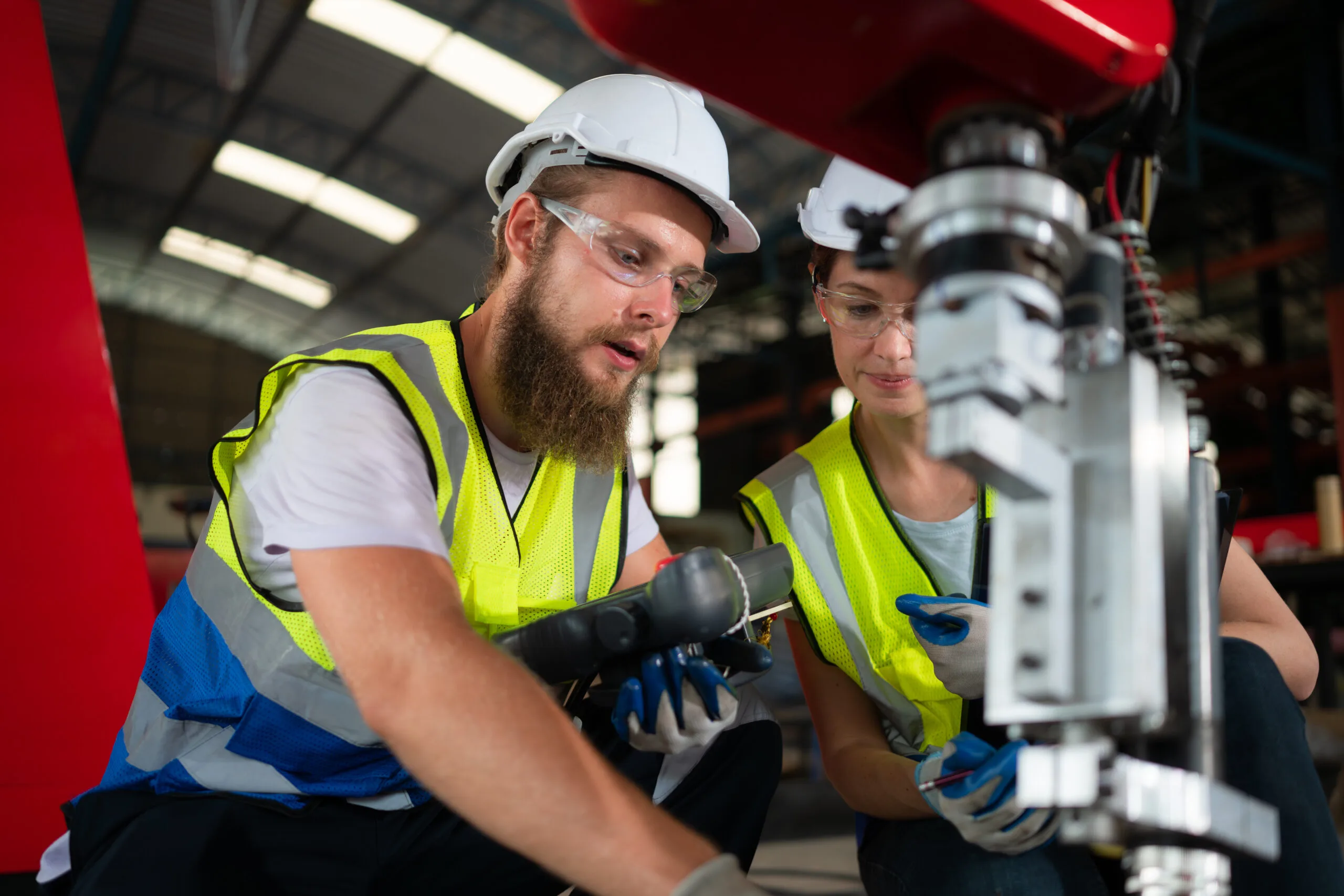 Both of engineers installing and testing a large robotic arm.