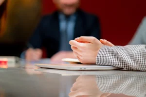 close up hands In conference red walls office workers are sitting at the head of the director discussing business plan